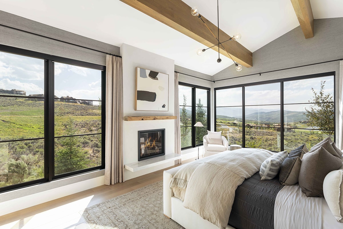 Fixed windows surrounding the bedroom create a tranquil place to sleep with a view of the greenery outside.