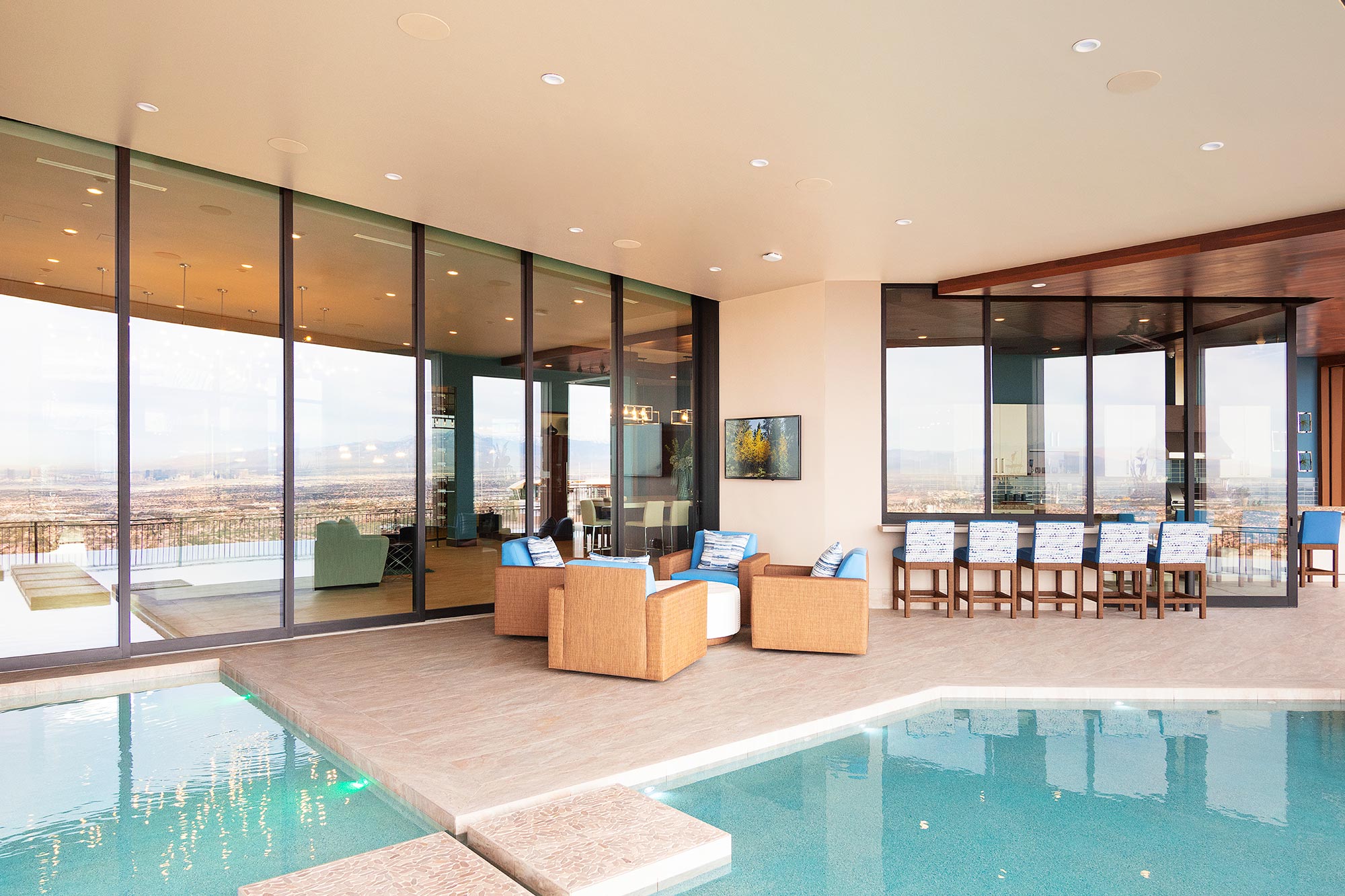 Massive glass walls connect the home to the pool and patio.