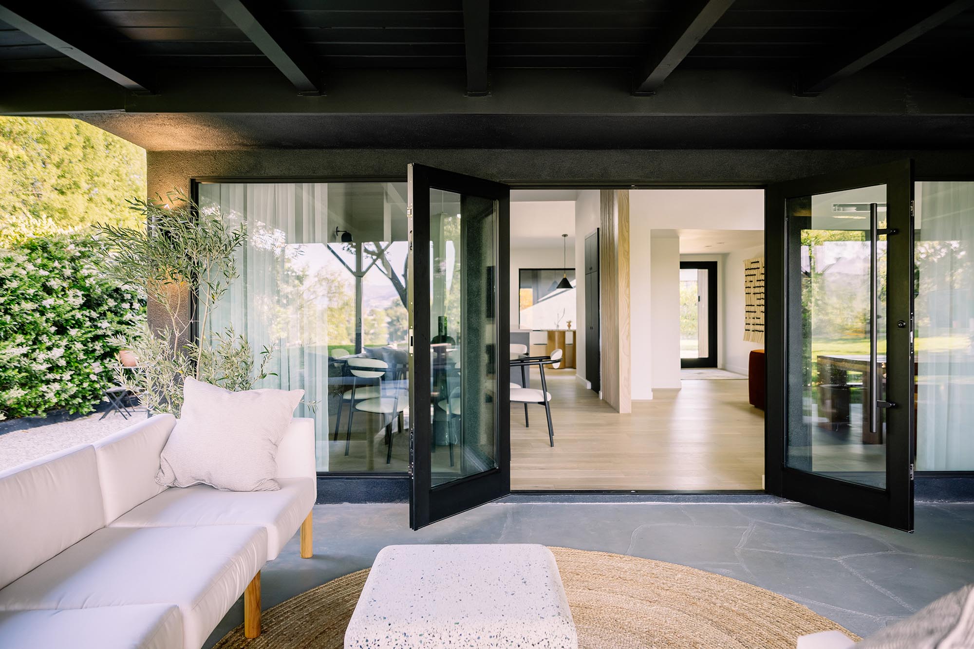 Two large, hinged doors connect the patio to the home.