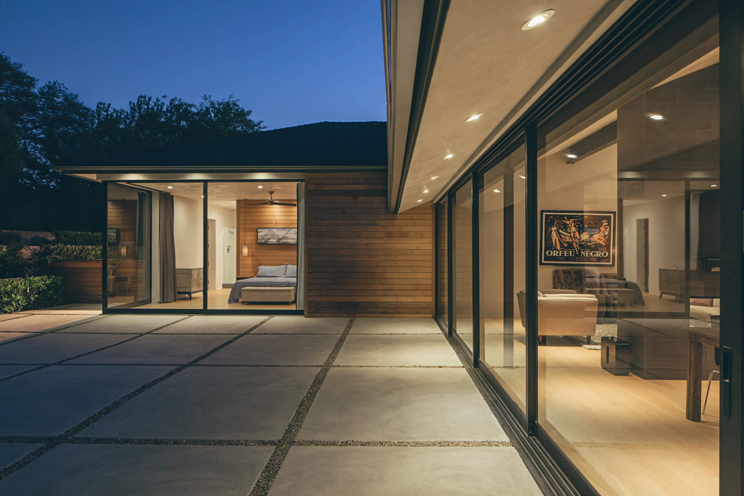 The backyard invites connection between the main living space and the master bedroom through large, multi-slide doors.