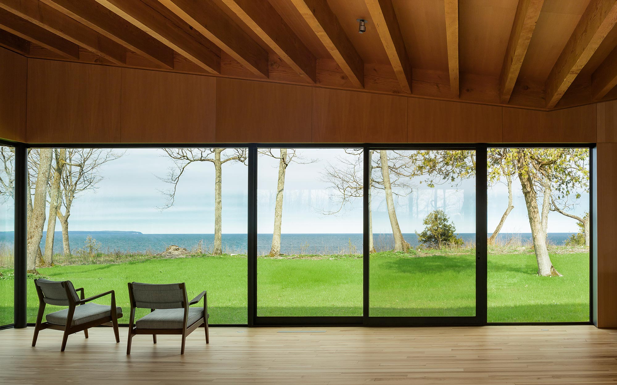 A green landscape is visible through a giant, multi-slide door.