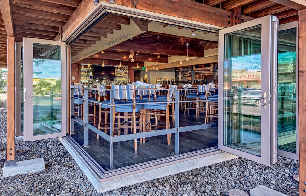 An attractive 90-degree bi-fold door completely opens up the corner of the restaurant to the outdoors.