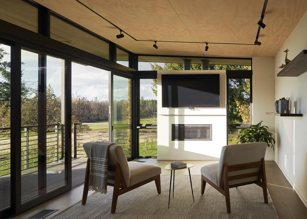 A comfortable sitting area opens to a patio through sliding glass doors.
