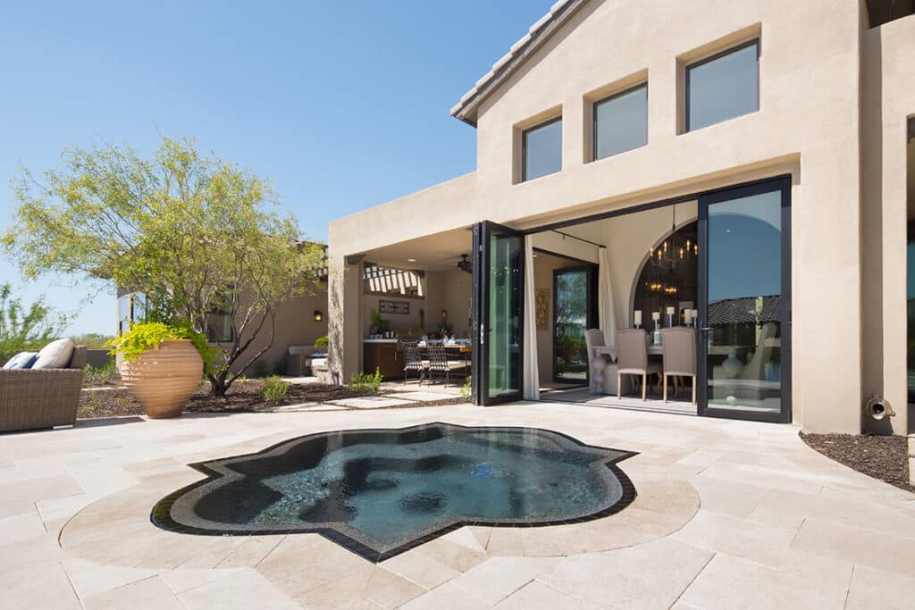 Stacking bi-fold glass doors leads the dining room to an outdoor spa.