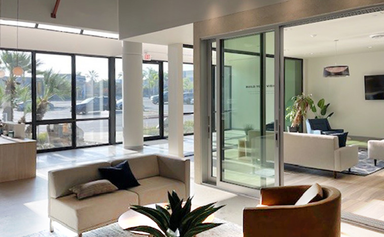 Interior view of the design studio highlighting the multi-slide door and window wall installed at the studio.