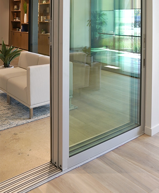 View of an open, stacking multi-slide door and track inside the design studio.