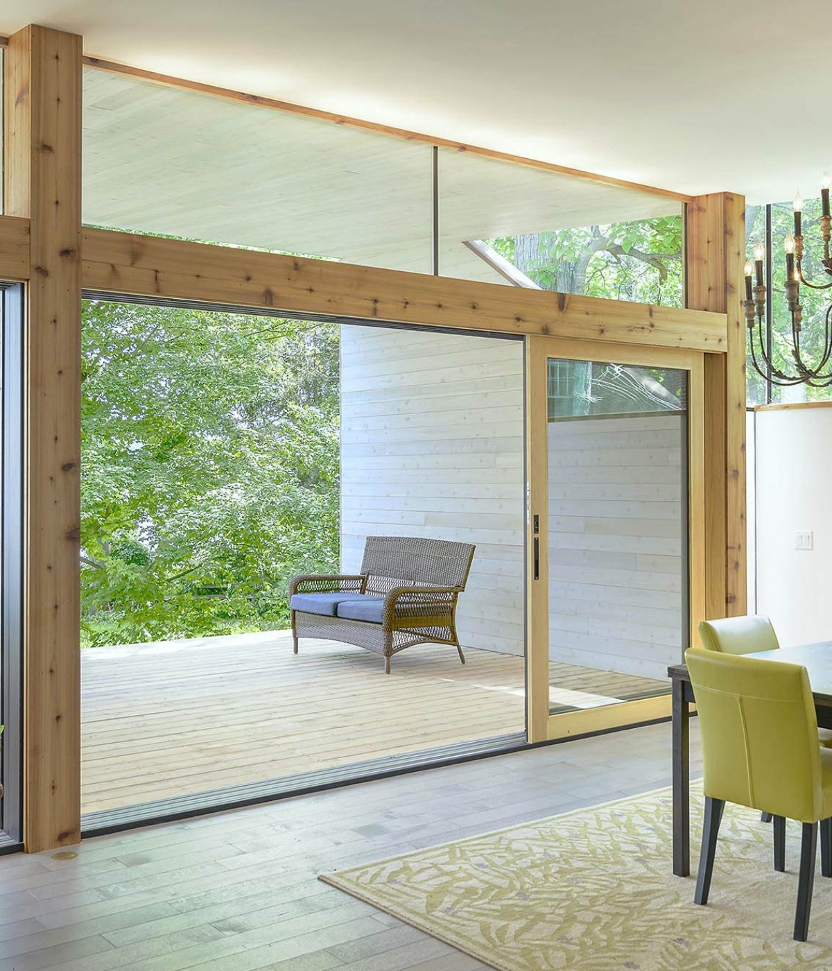 The large, wooden multi-slide door accentuates the natural touches in this home.