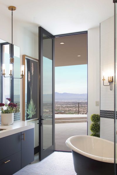 A large hinged door opens the bathroom to a balcony.