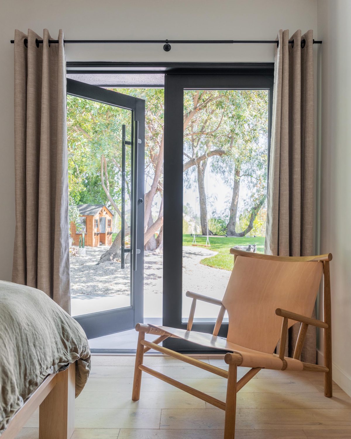 A massive, hinged door opens this bedroom to a pathway.