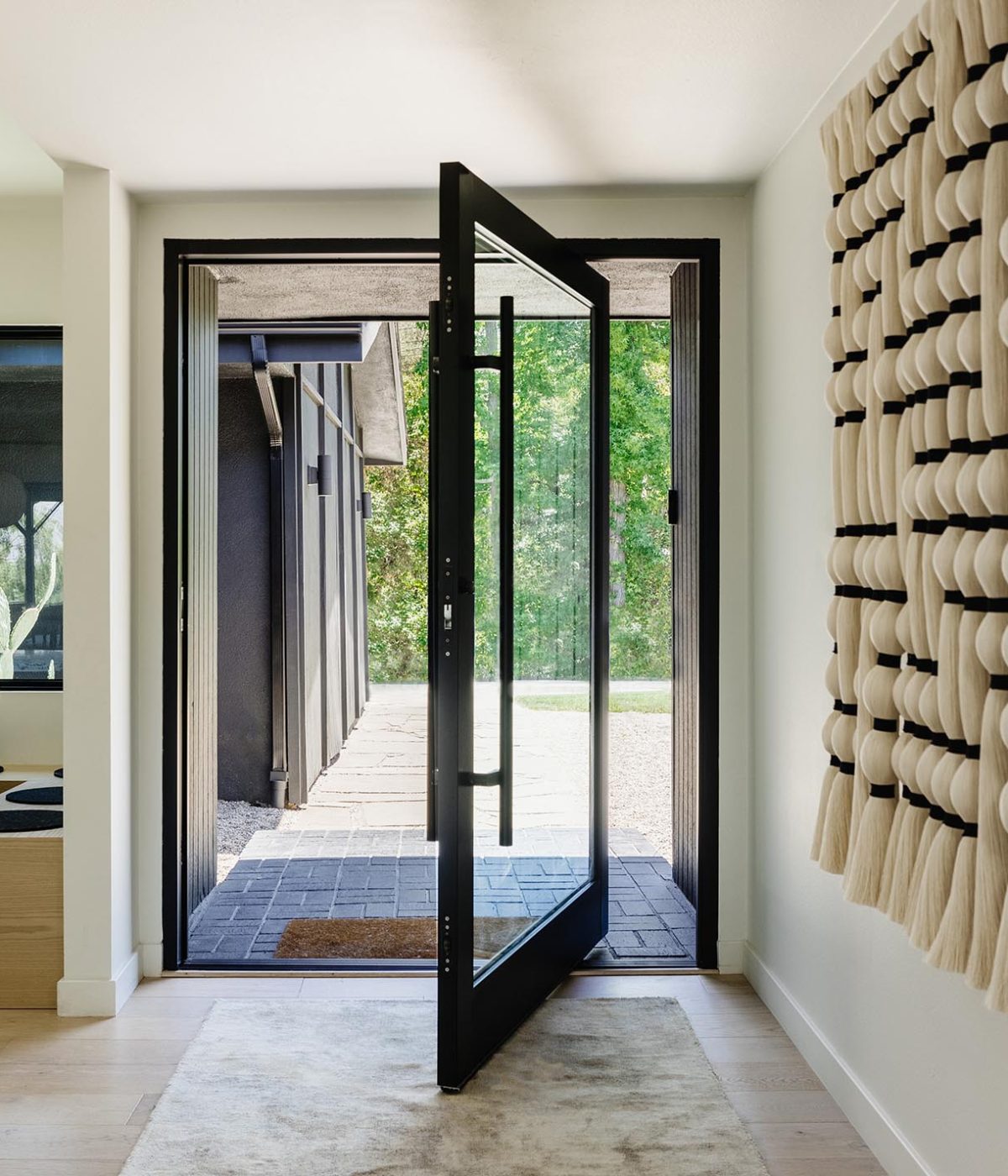 A massive pivot door creates a stunning entryway.