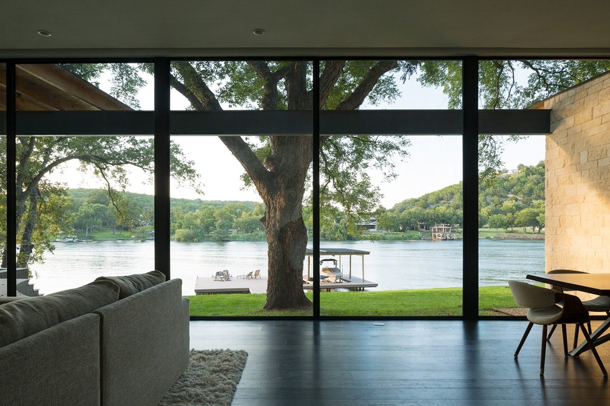 The combination of a floor-to-ceiling sliding door and window wall allows for a full, practically uninterrupted view of the riverfront.