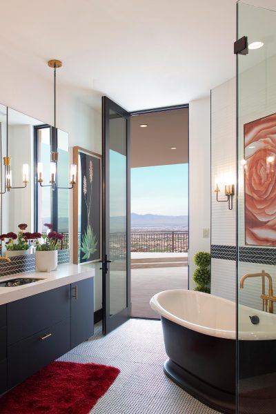 A floor-to-ceiling pivot door connects the bathroom to a balcony.