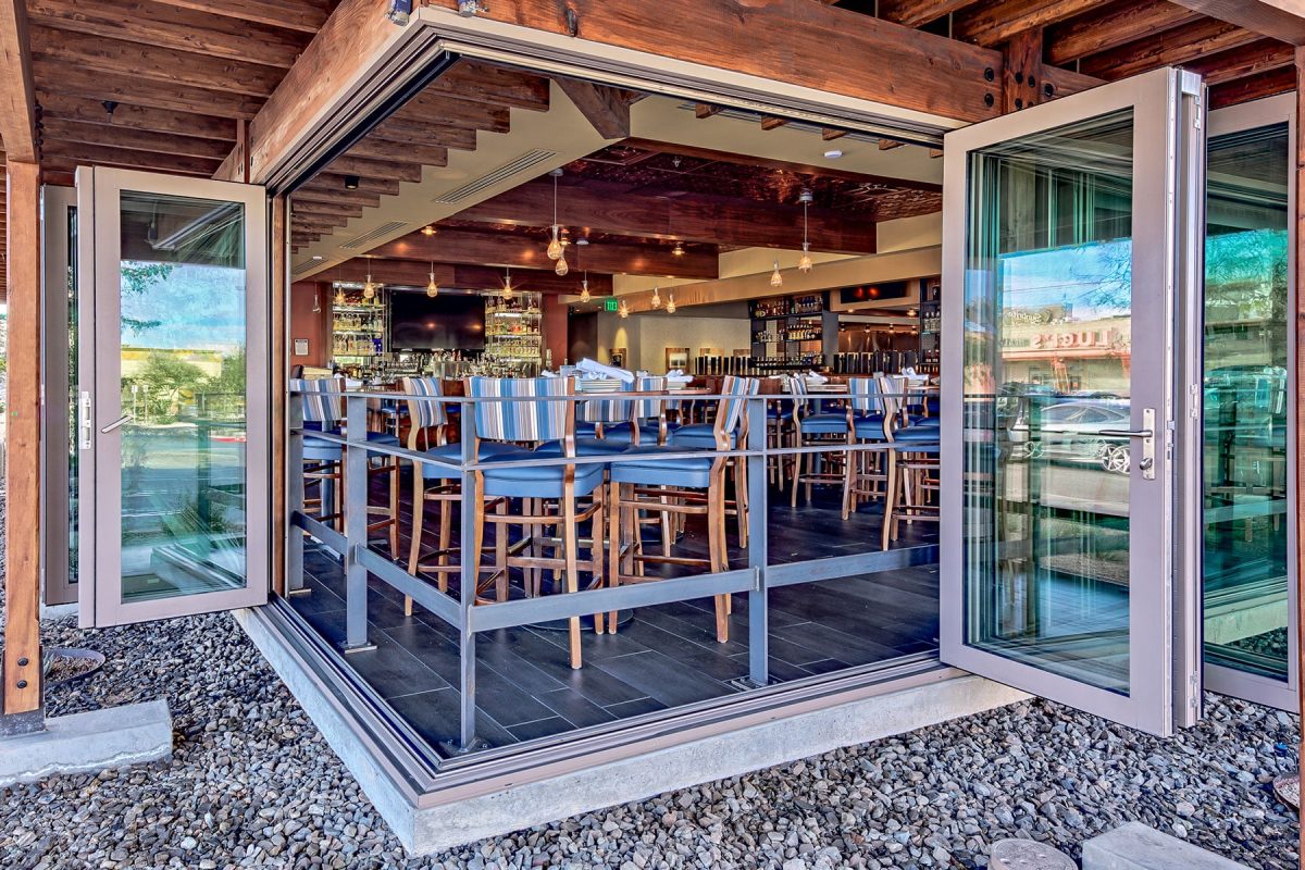 An attractive 90-degree bi-fold door completely opens up the corner of the restaurant to the outdoors.